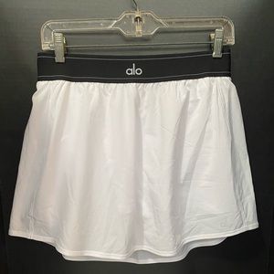 Alo Yoga Match Point Tennis Skirt in white with built-in shorts. Women’s size L.